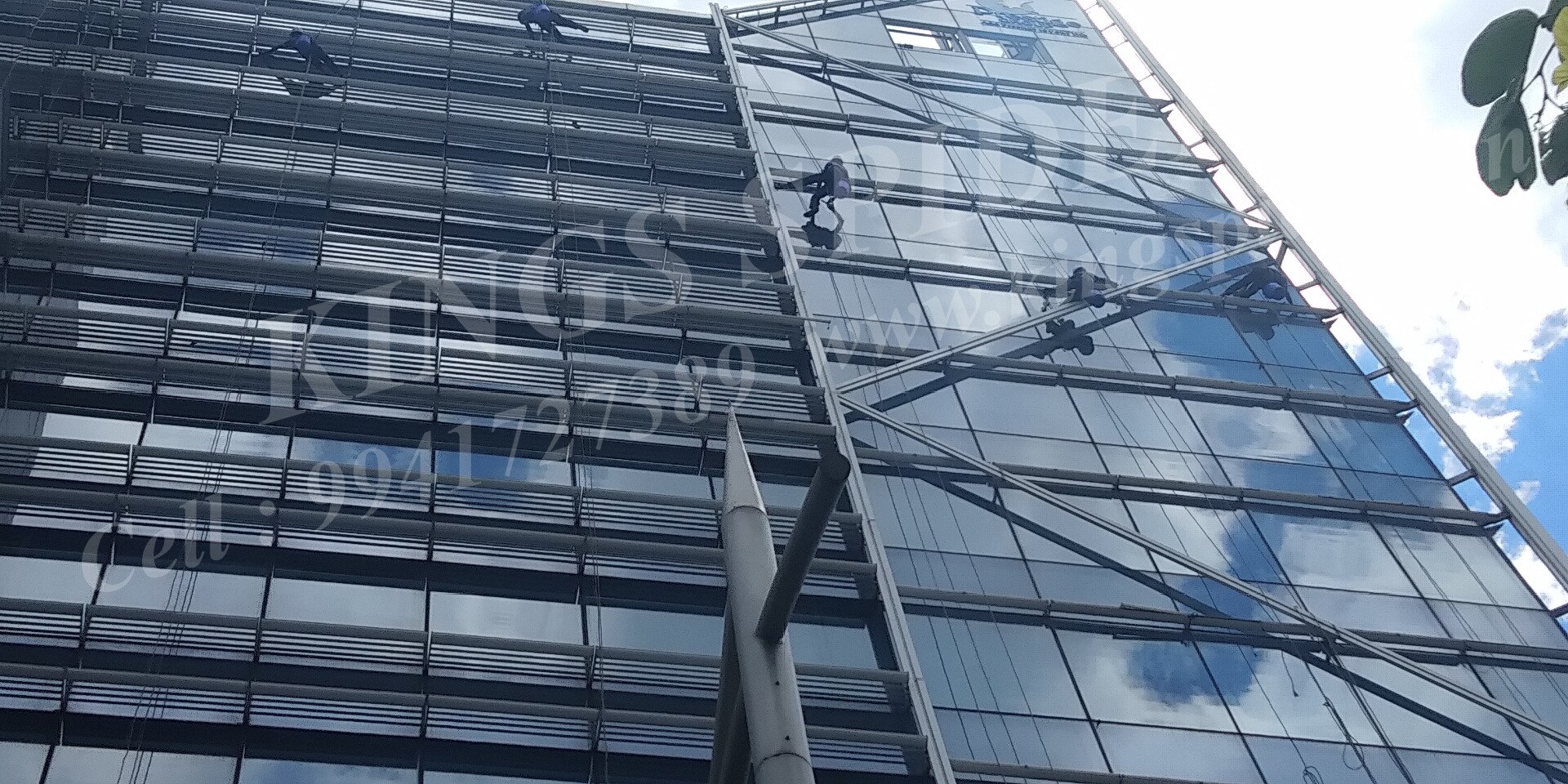 Technician descending a glass facade